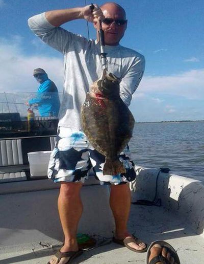 1guy-baot-with-huge-flounder